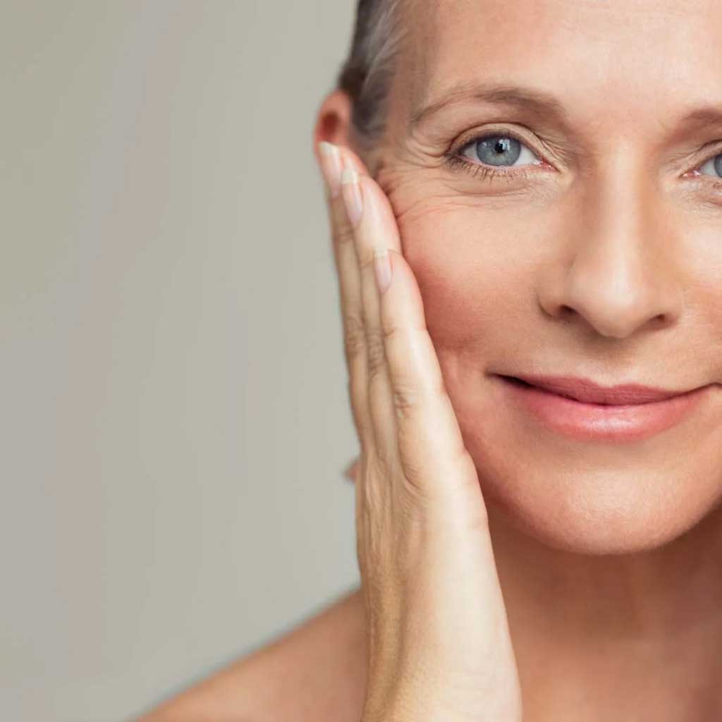 Model Applying Absolute Aromas Rejuvenate Face Oil - Natural Skincare